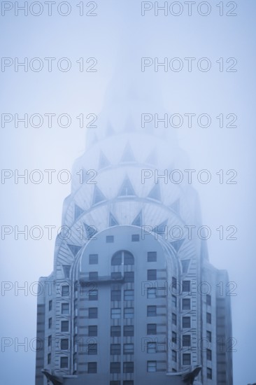 The tower of the Crysler Building in the fog, New York, USA