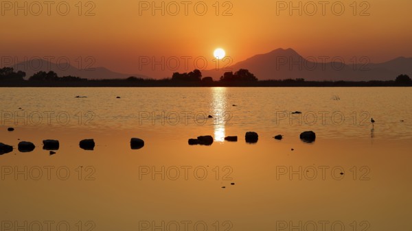Tranquil landscape with sunset over a lake and distant mountains, salt lake, Tigaki, nature reserve, hydro biotope, Kos, Dodecanese, Greek Islands, Greece