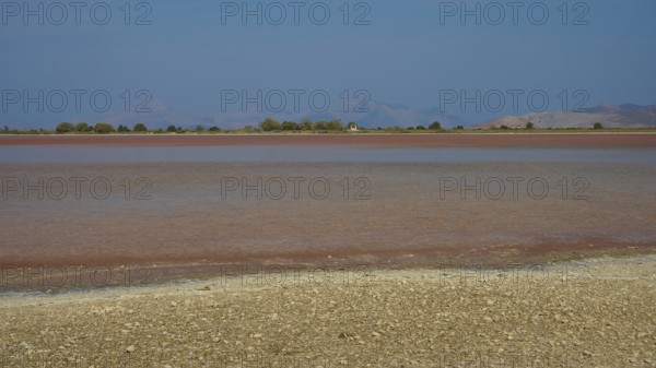 Lake with blue sky and brown shore in the distance, salt lake, Tigaki, nature reserve, hydro biotope, Kos, Dodecanese, Greek Islands, Greece