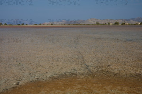 Dry landscape with far horizon and distant mountains, salt lake, Tigaki, nature reserve, hydro biotope, Kos, Dodecanese, Greek Islands, Greece