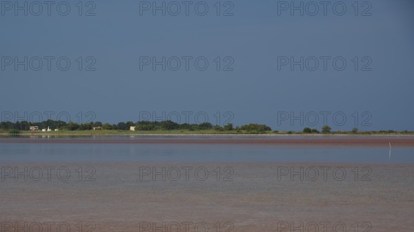 Tranquil coastal scene with blue sky and reflecting water, salt lake, Tigaki, nature reserve, hydro biotope, Kos, Dodecanese, Greek Islands, Greece