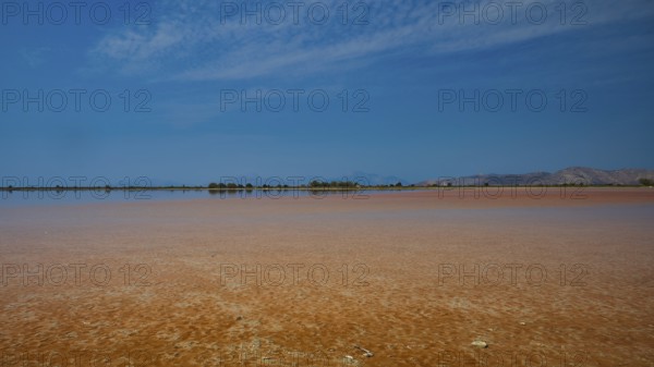 Wide, open landscape with a lake under a narrow blue sky, quiet atmosphere, salt lake, Tigaki, nature reserve, hydro-biotop, Kos, Dodecanese, Greek Islands, Greece