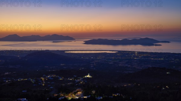 Sweeping panoramic view of coastal landscape at sunset, shadows and city lights visible, salt lake, Tigaki, nature reserve, hydro biotope, Kos, Dodecanese, Greek Islands, Greece