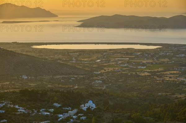 A view of a village and fields in front of the sea at sunset, salt lake, Tigaki, nature reserve, hydro biotope, Kos, Dodecanese, Greek Islands, Greece