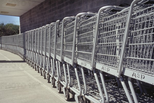 Shopping trolleys pushed together in front of a supermarket, New Jersey, USA