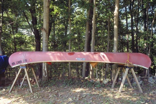 Jacked up canoe in front of a forest, New Jersey, USA