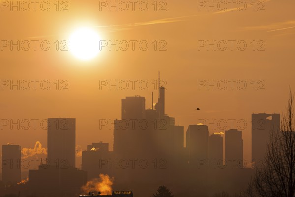 The sun rises behind Frankfurt's banking skyline, Frankfurt am Main, Hesse, Germany