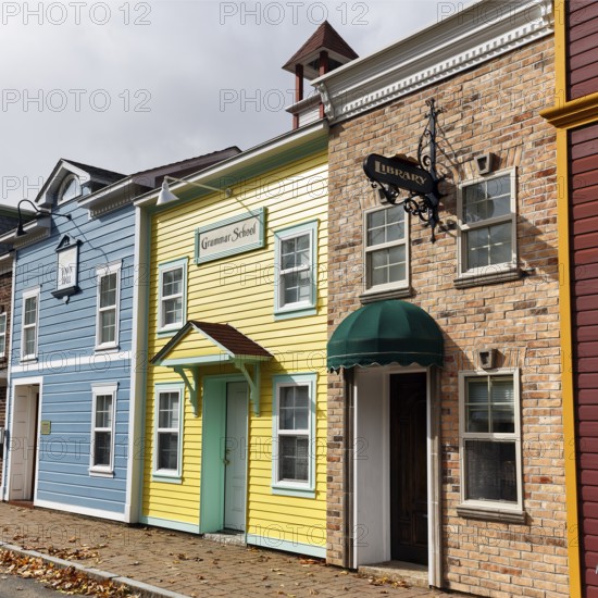 Replica, historic town hall, elementary school, library, colorful facades, signs with inscription, fall leaves, boutique hotel, theme hotel Adventure Suites Hotel, North Conway, Kancamagus Highway, White Mountain, New Hampshire, New England, USA