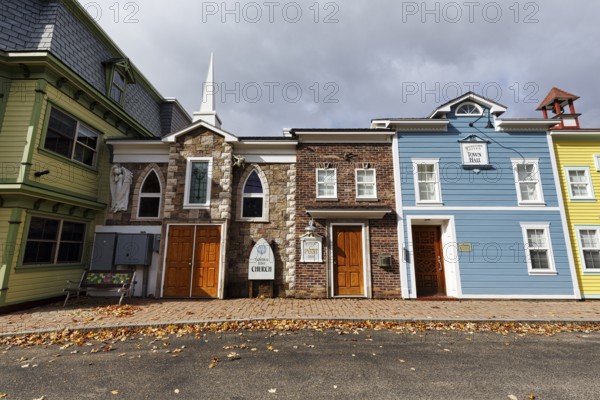 Replica, historic town hall, post office, church, colorful facades, signs with inscription, fall leaves, boutique hotel, theme hotel Adventure Suites Hotel, North Conway, Kancamagus Highway, White Mountain, New Hampshire, New England, USA
