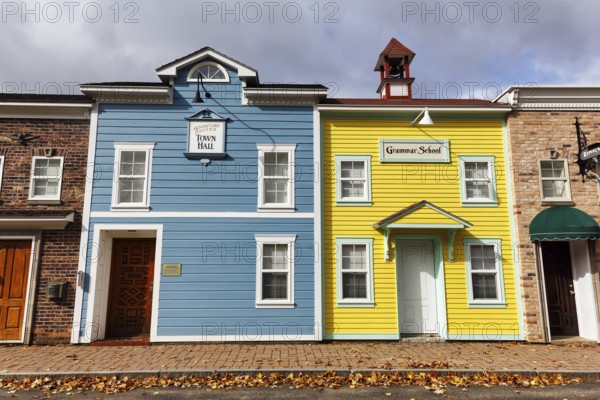 Replica, historic town hall, historic elementary school, colorful facades, signs with inscription, fall leaves, boutique hotel, theme hotel Adventure Suites Hotel, North Conway, Kancamagus Highway, White Mountain, New Hampshire, New England, USA