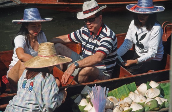 Dealer and customer in their boats at the Damnoen Saduak floating market, Thailand, December 2002, vintage, retro, old, historic