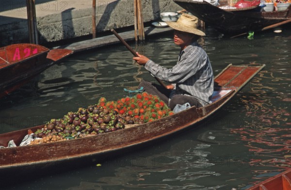 Merchant in his boat at Damnoen Saduak Floating Market, Thailand, December 2002, vintage, retro, old, historic