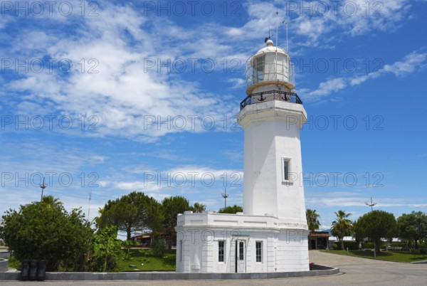White lighthouse against a cloudy sky surrounded by palm trees and a road, lighthouse, Batumi, Black Sea, Ajara region, Adjara, autonomous republic, Georgia
