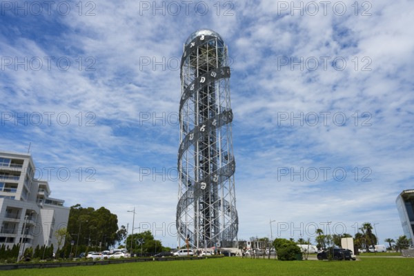 Large steel tower with spiral architecture against a slightly cloudy sky, Alphabetic Tower, Georgian Alphabet Tower, Miracle Park, Batumi, Black Sea, Ajara region, Adjara, Autonomous Republic, Georgia