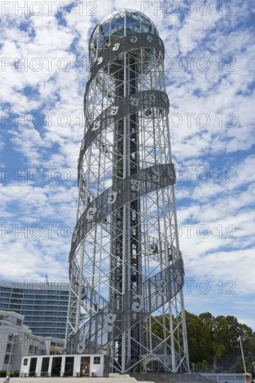 Towering tower with spiral steel structure against a cloudy sky, Alphabetic Tower, Georgian Alphabet Tower, Miracle Park, Batumi, Black Sea, Adjara Region, Adjara, Autonomous Republic, Georgia