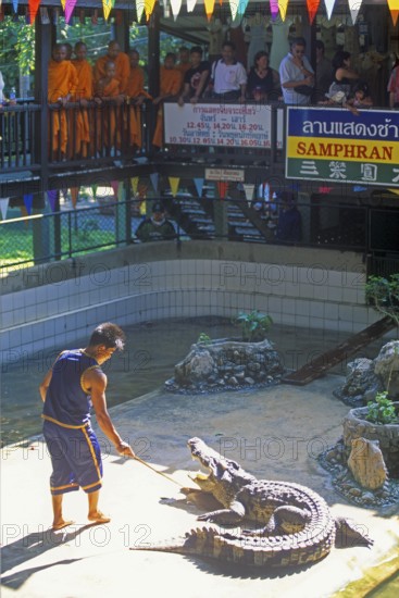 Spectators, monks, performance with crocodiles at Samphran Elephant Ground and Zoo near Bangkok, Thailand, December 2002, vintage, retro, old, historic