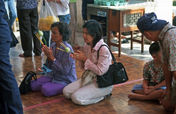 People, woman praying, Phra Mongkhonbophit, Ayutthaya, Thailand, December 2002, vintage, retro, old, historical