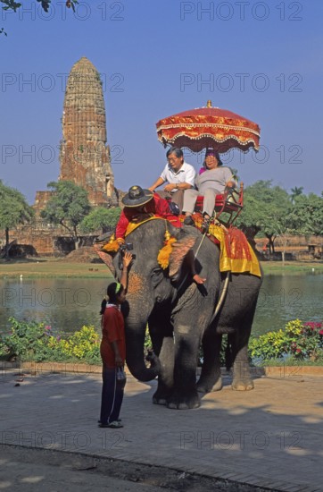 People, tourists, temple ruins, riding on an elephant through ancient sights, Ayutthaya, Thailand, December 2002, vintage, retro, old, historical