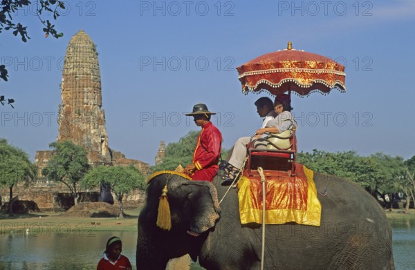 People, tourists, temple ruins, riding on an elephant through ancient sights, Ayutthaya, Thailand, December 2002, vintage, retro, old, historical