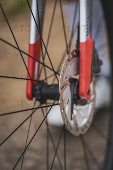 Close-up of a bicycle part with red and silver design showing the mechanics and brake disc, Triathlon, Calw, Germany