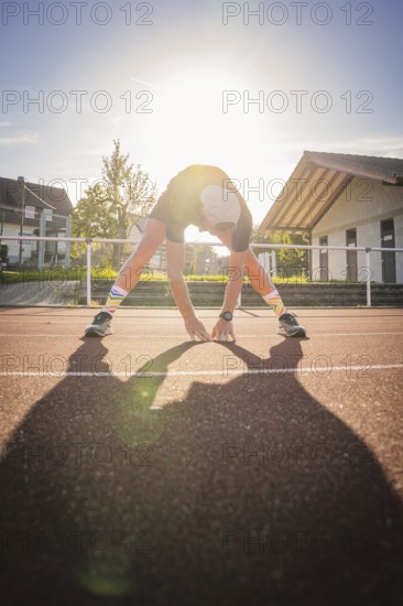 Person stretching on sunny track, triathlon, Calw, Germany