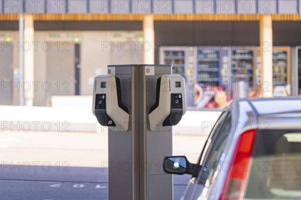 Detailed view of an electric vehicle at a charging station in front of parking lots, e-charging park, Merklingen, Germany