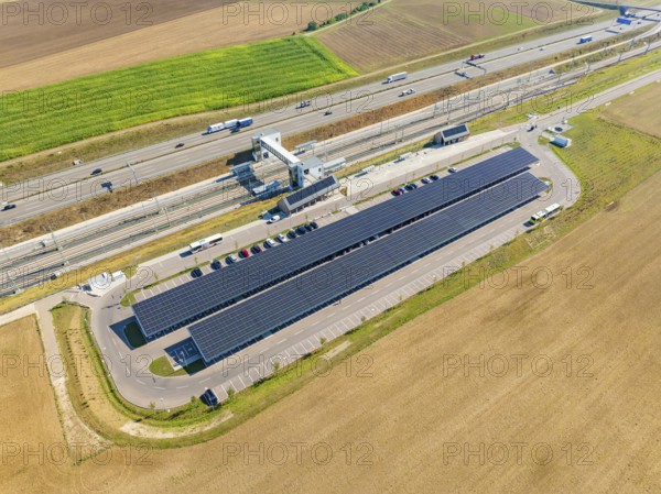 Solar system and infrastructure next to a motorway in the middle of fields, e-charging park, Merklingen, Germany