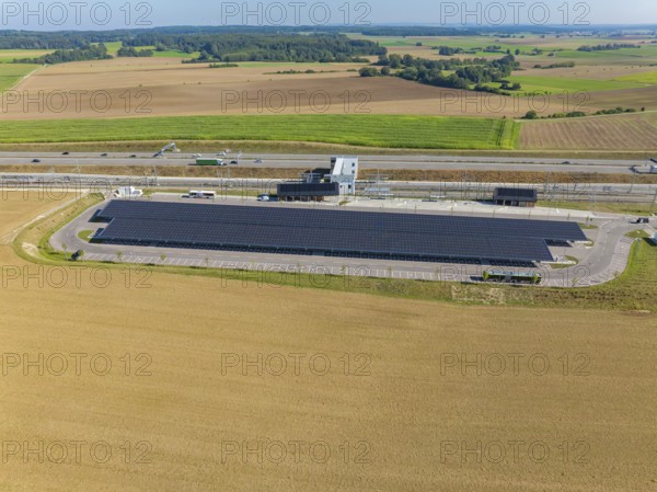 Solar system next to a motorway, embedded in an agricultural environment, e-charging park, Merklingen, Germany
