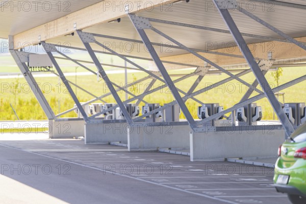Modern architecture of a parking garage with charging stations and metal supports, e-charging park, Merklingen, Germany