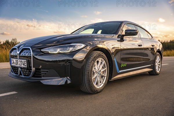 Shiny black car on a road with blue sky in the background, BMW i7 electric car, Deer e-Carsharing, Calw, Germany