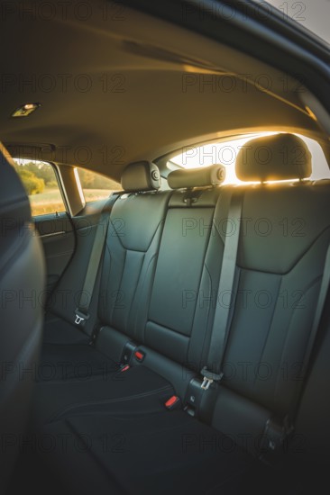 Interior view of car with back seats in sunset light, BMW i7 electric car, Deer E- Carsharing, Calw, Germany