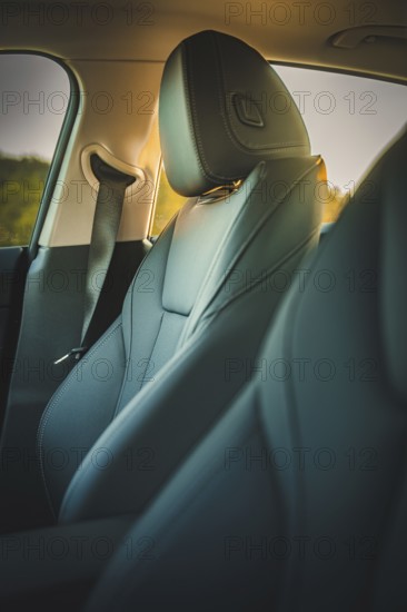 Close-up view of a comfortable and stylish car seat in the interior with dim lighting, BMW i7 electric car, Deer e-Carsharing, Calw, Germany