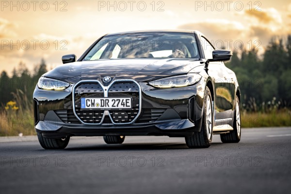 BMW on open road with background in evening light, BMW i7 electric car, Deer e-Carsharing, Calw, Germany