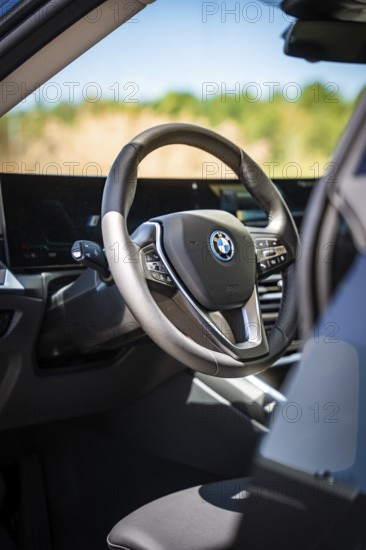 View of the modern steering wheel and display in the interior of a car, BMW i7 electric car, Deer e-Carsharing, Calw, Germany