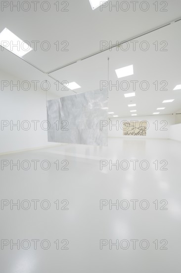 Minimalist gallery space with hanging metal artwork in the foreground, Schauwerk, Sindelfingen, Germany