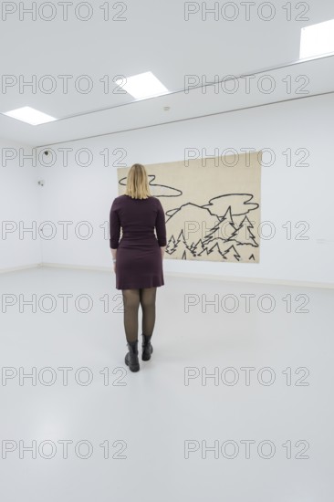 A woman stands in front of a modern work of art in a bright gallery, Schauwerk, Sindelfingen, Germany