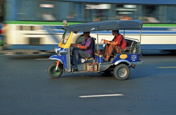 Passenger in a three-wheeled tuk tuk taxi, blurred, Bangkok, Thailand, December 2002, vintage, retro, old, historic