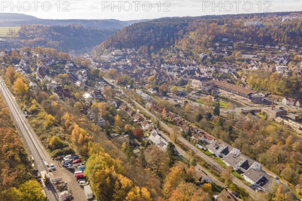 City landscape with autumn colors and railroad tracks from a bird's eye view, Calw, Black Forest, Germany