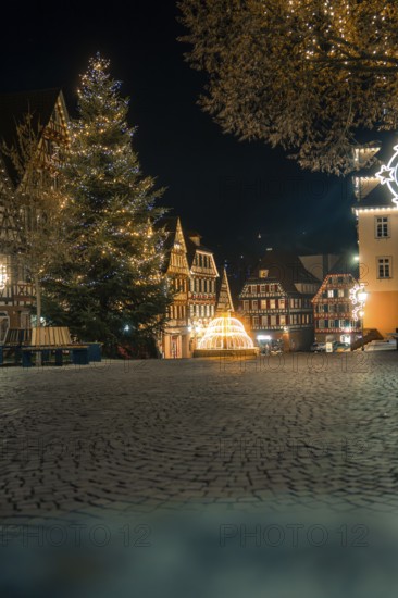 Atmospheric view of the old town at night, illuminated with lights, Christmas tree and half-timbered houses, Calw, Black Forest, Germany