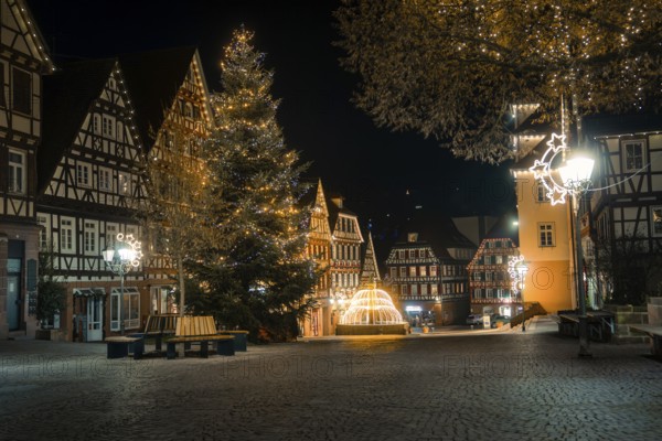 Illuminated square in an old town with half-timbered houses, Christmas tree and festive decoration, Calw, Black Forest, Germany