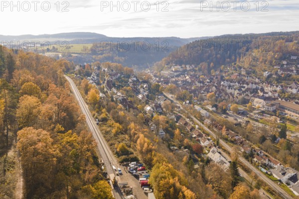 Autumn village surrounded by hills and forests with a clear view from above, Calw, Black Forest, Germany