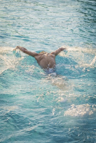 A swimmer in a blue pool moves powerfully through the water, Triathlon, Calw, Germany