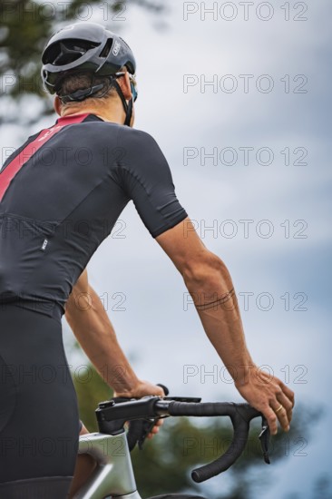 Close-up of cyclist looking at handlebars and concentrating, triathlon, Calw, Germany