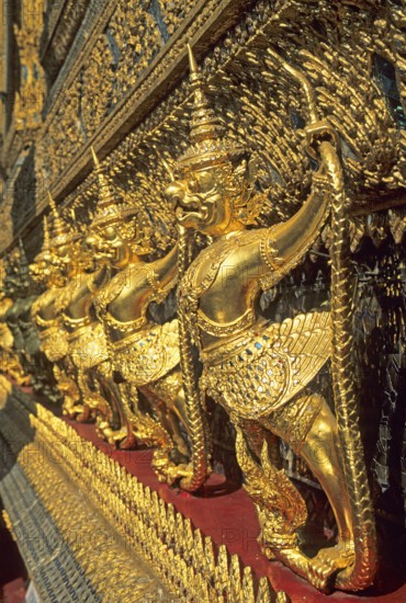 Golden mythical creatures, statues, Garudas, at Wat Phra Kaeo, Bangkok, Thailand, December 2002, vintage, retro, old, historical