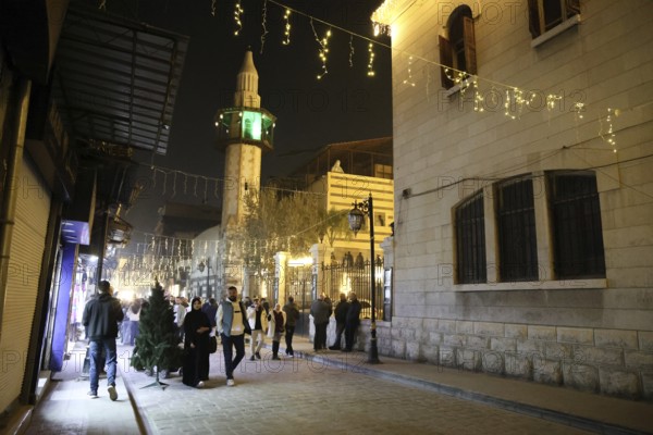 In Damascus, Syria, on December 25, 2025, festive scenes filled the streets and churches of the Bab Touma district, where thousands of people gathered to celebrate Christmas Eve amid holiday decorations and lights, Damascus, Damascus, Syria