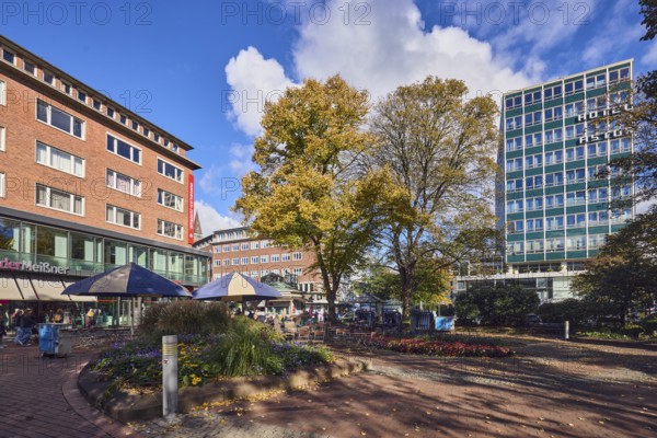 Pedestrian zone, Hotel Astor Kiel by Campanile, leather shop, Meissner leather, general architecture, high-rise building, modern architecture, square, park, flower bed, trees, autumn leaves, paths, lantern, outdoor area of a restaurant, blue sky, cumulus clouds, Holstenplatz, Kiel, state capital, district-free city, Schleswig-Holstein, Germany