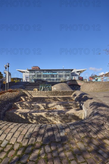 Wunderino Arena multi-purpose hall or former Baltic Sea Hall, pedestrian zone, square, fountain, building material brick, cobblestones and paving stones, lantern, paving stone and cobblestone walkway, bare winter trees, blue sky, splash, Europaplatz, Kiel, state capital, district-free city, Schleswig-Holstein, Germany