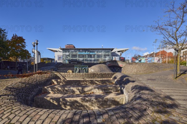 Wunderino Arena multi-purpose hall or former Baltic Sea Hall, pedestrian zone, square, fountain, building material brick, cobblestones and paving stones, lantern, paving stone and cobblestone walkway, bare winter trees, blue sky, splash, Europaplatz, Kiel, state capital, district-free city, Schleswig-Holstein, Germany