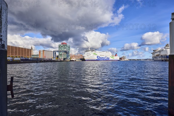 Kiel Fjord, harbour, duckdalben, ferry, seaport Kiel GmbH and Co. KG, quay, portal crane, general architecture, lake port Kiel GmbH and Co. KG, water surface with small waves, blue sky, cumulus clouds, stratocumulus clouds, white and dark clouds, Kiel, state capital, district-free city, Schleswig-Holstein, Germany