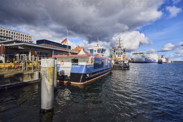 Kiel Fjord, harbor, wharf, passenger ship, tugboat, ferry ship, ships, general architecture, water surface with small waves, blue sky, cumulus clouds, stratocumulus clouds, white and dark clouds, Kiel, state capital, district-free city, Schleswig-Holstein, Germany